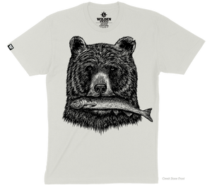 A light beige t-shirt with a black printed design of a grizzly bear's head holding a fish in its mouth.