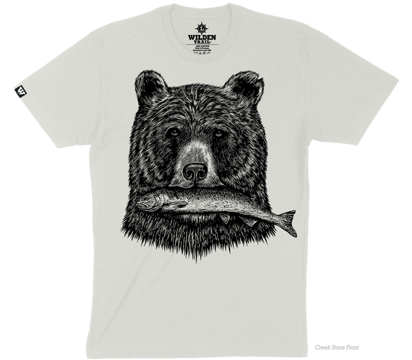 A light beige t-shirt with a black printed design of a grizzly bear's head holding a fish in its mouth.