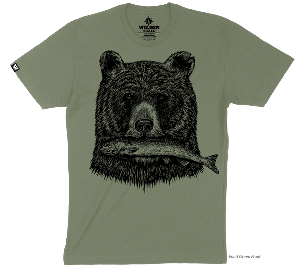 A muted green t-shirt with a black printed design of a grizzly bear's head holding a fish in its mouth.