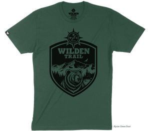 Emblem design with a black bear, mountains, and compass logo inside the emblem with the words "Wilden Trail" at the top.